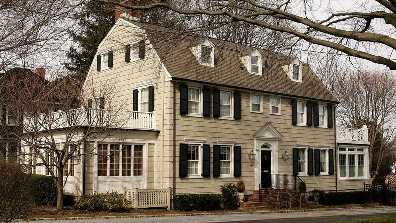 The Amityville Horror house as it looked in 2005, after its distinctive “eye windows” were sadly replaced with boring, un-scary square ones. Image: Paul Hawthorne/Getty Images